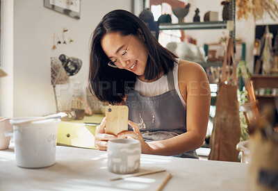 Buy stock photo Phone photo, pottery and woman at a studio for art entrepreneurship, social media update and creative job. Small business, creativity and girl with a mobile picture of professional clay work