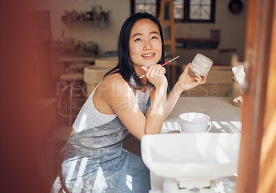 Buy stock photo Asian woman, pottery and thinking while painting in workshop, creative studio and design startup. Happy female painter, clay ceramics and brush ideas, artistic pattern and dreaming in small business