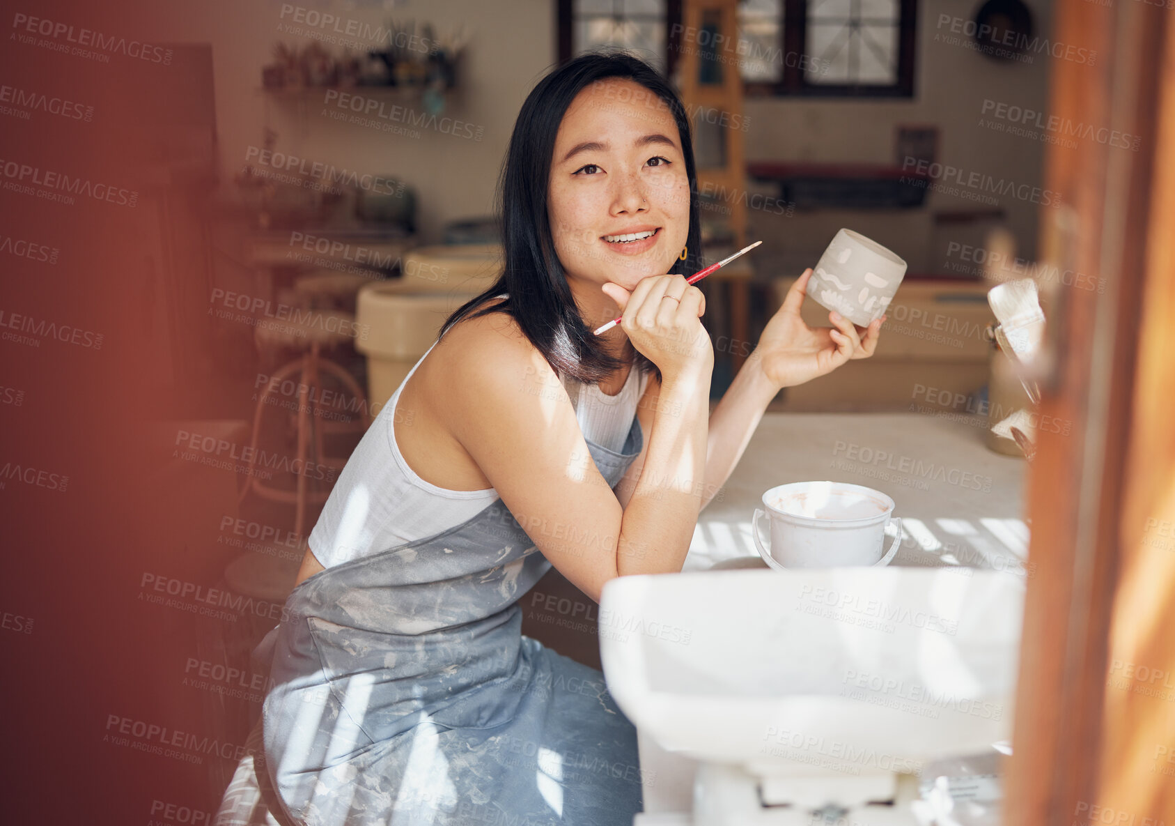 Buy stock photo Asian woman, pottery and thinking while painting in workshop, creative studio and design startup. Happy female painter, clay ceramics and brush ideas, artistic pattern and dreaming in small business