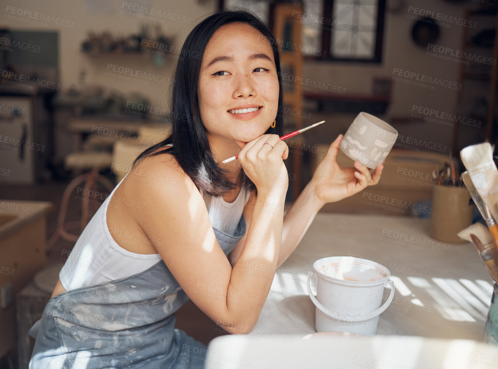 Buy stock photo Woman, potter or thinking of product design ideas, cup painting vision or creative color in Asian pottery studio. Smile, happy or clay store worker and mug goals, small business or ceramic workshop