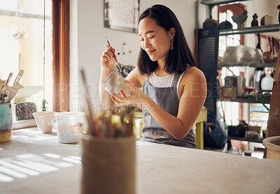 Buy stock photo Pottery, art and creative with an asian woman in a studio for design or ceramics hobby as an artisan. Manufacturing, pattern and artist with a female potter sitting in her workshop  as a sculptor