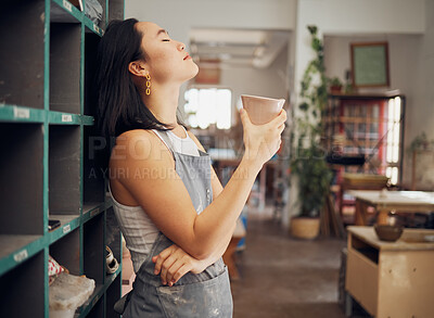 Buy stock photo Pottery, coffee and relax with an asian woman taking a break from design in her studio or workshop. Creative, rest and small business with a female artist standing eyes closed in her ceramics startup