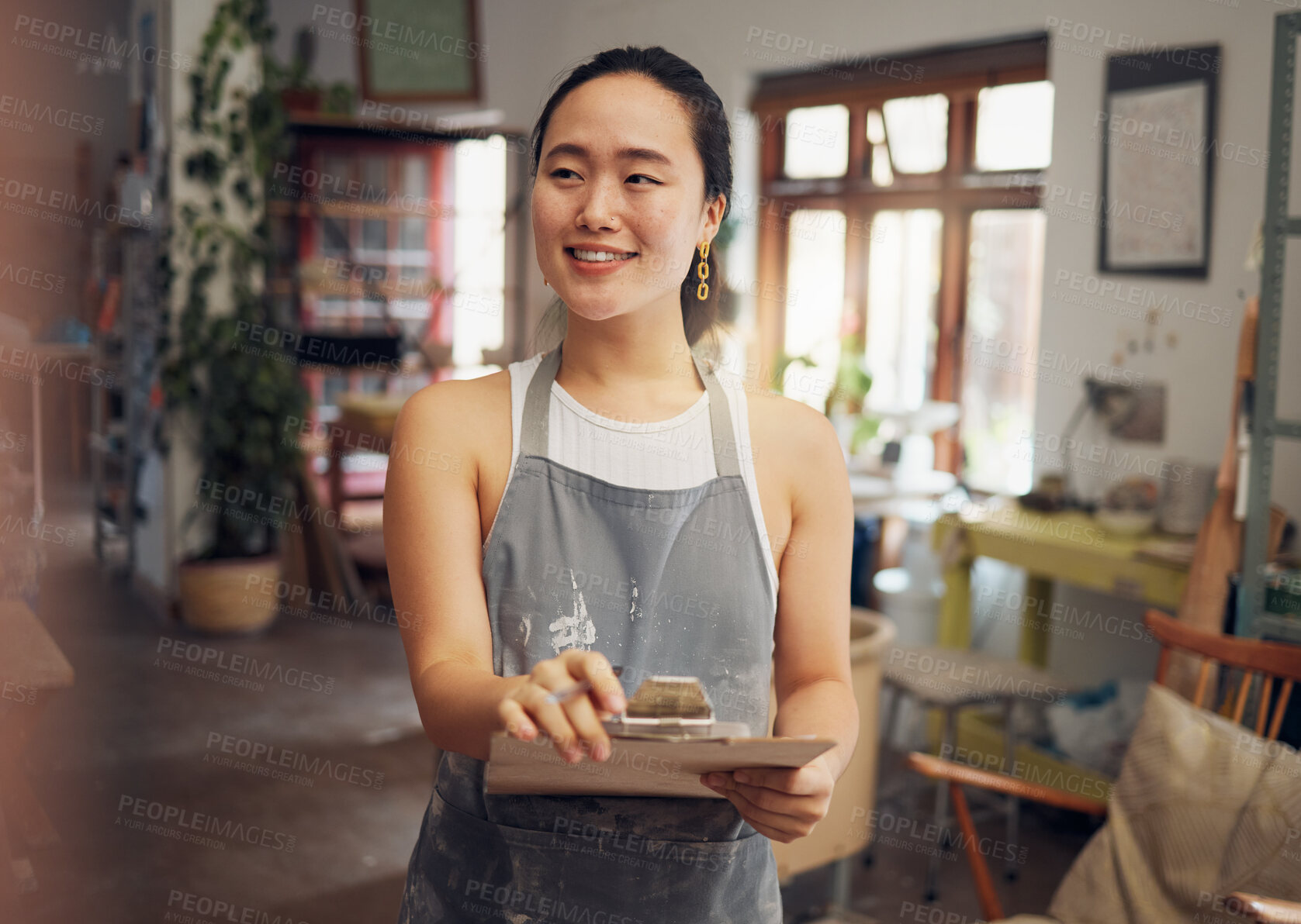 Buy stock photo Asian woman, clipboard and creative business owner with smile for art, design or startup in the workshop. Happy Japanese woman smiling for management, inspection or checklist for arts and crafts