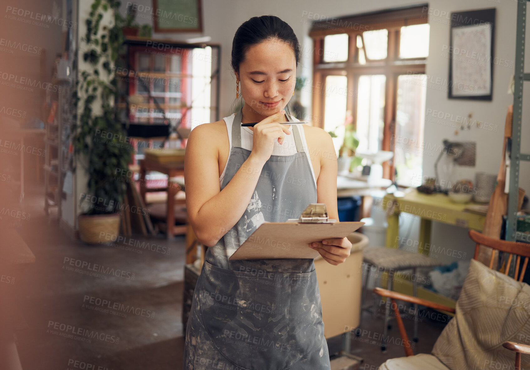 Buy stock photo Woman, thinking or clipboard in pottery studio, ceramic small business or Asian art workshop on class schedule. Mud, craft or designer worker with clay vision, ideas or innovation on paper documents