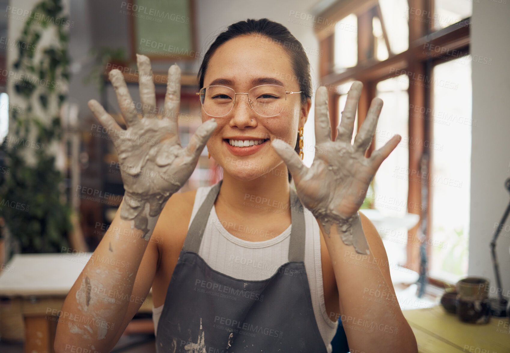 Buy stock photo Pottery, happy and hands of a portrait woman at a messy workshop for art, design and work. Small business, dirty and creative artist with clay at a studio for creativity and artistic entrepreneurship