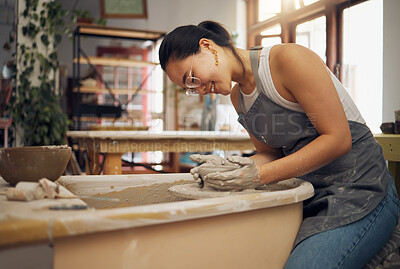 Buy stock photo Pottery wheel, workshop and startup business woman manufacturing creative art product with hands. Happy asian potter artist working in clay or ceramics retail industry, studio or class with pride