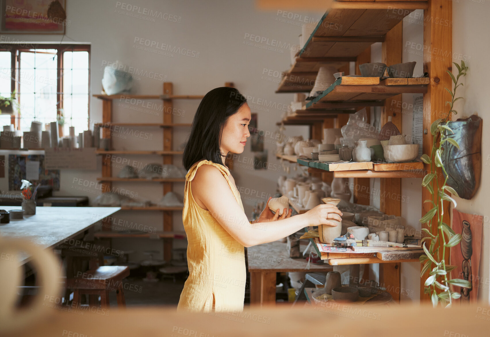 Buy stock photo Woman, ceramic product and shelf in workshop, creative studio and manufacturing startup. Female small business owner, pottery designer and artist working with sculpture, creativity and craft process