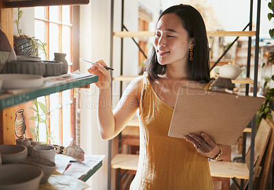 Buy stock photo Pottery stock check, business woman and clipboard data of a entrepreneur with store information. Happy, counting and startup worker busy working on a ceramic inventory search for accounting audit