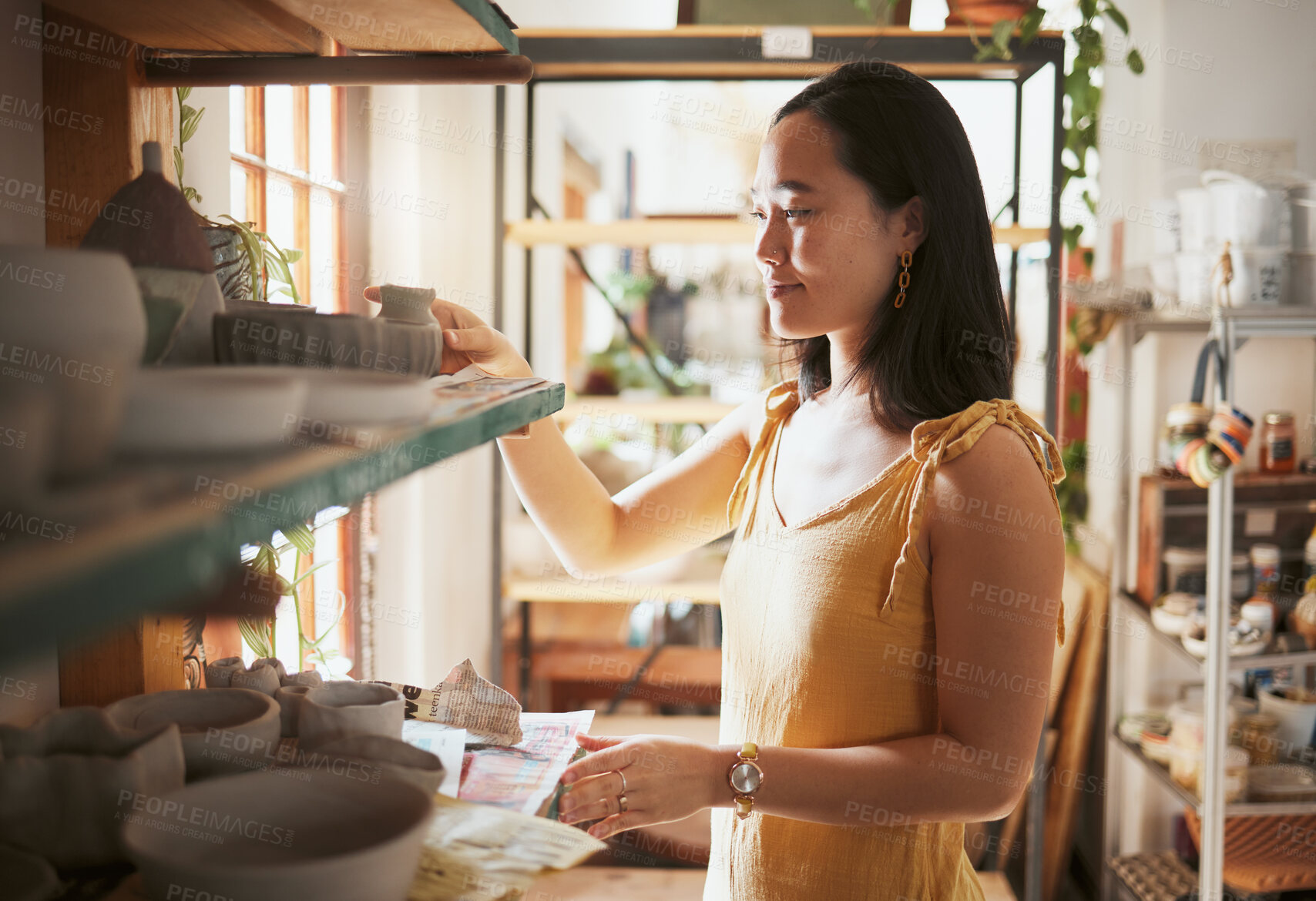 Buy stock photo Pottery, startup and display with a woman entrepreneur working in a studio, selling products for retail. Small business, manager or sale with a female owner at work in a workshop for artistic design