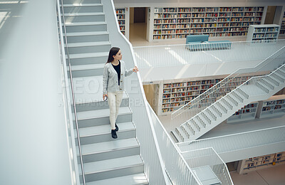 Buy stock photo Woman, staircase and walking in the library for education, learning or knowledge from books in the mall. Female having a walk down stairs in big book shop or store for reading or development indoors