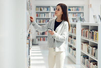 Buy stock photo Library, book choice and student with phone in university, college or school. Learning, education scholarship or woman holding mobile looking for books by bookshelf for reading, knowledge or studying