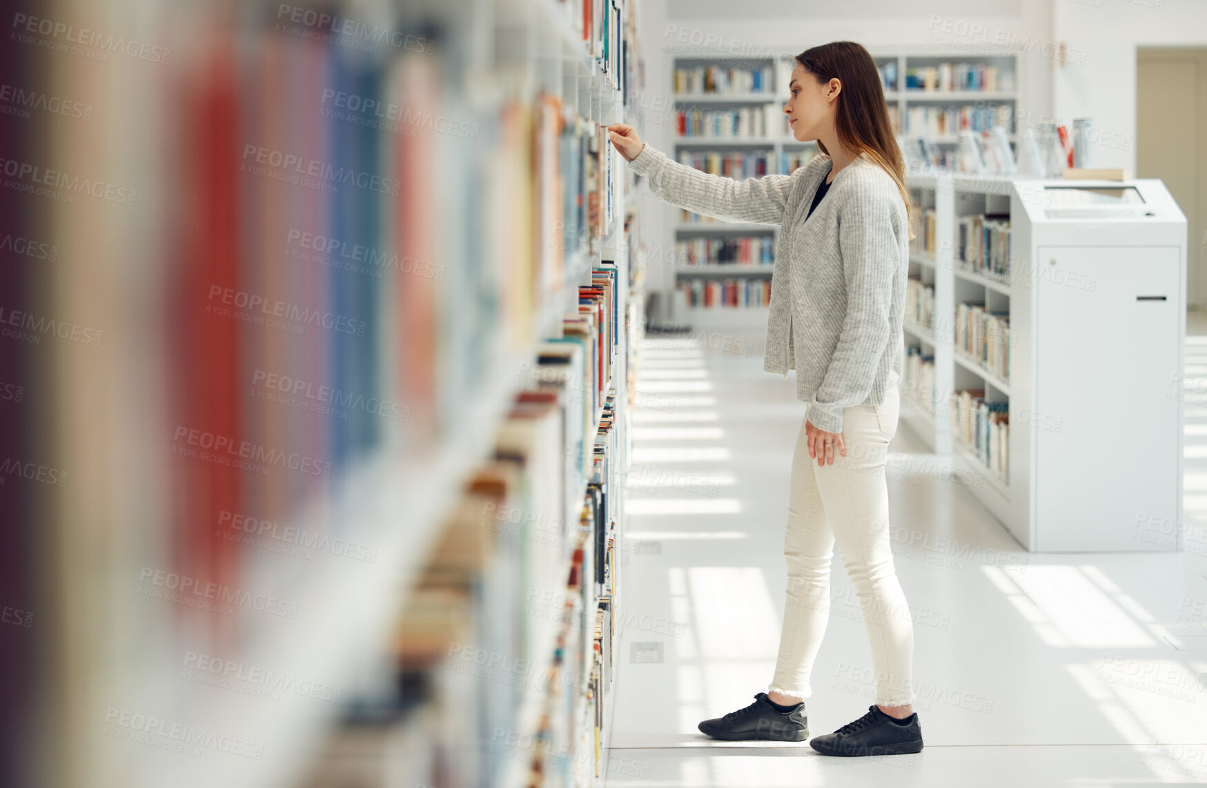 Buy stock photo Woman, student and research in library for books, knowledge or learning at bookstore for education. Female looking at bookshelf in study for project, assignment or thesis for college scholarship