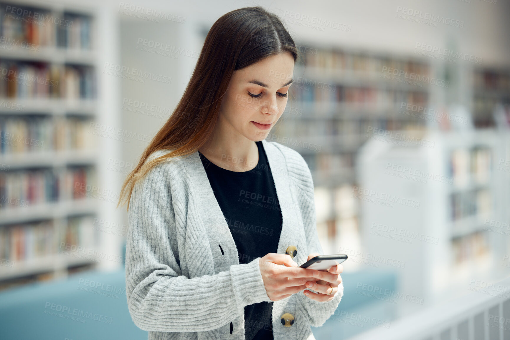 Buy stock photo Smartphone, bookstore and woman typing a text message, reading blog or doing research on internet. Books, library and young student networking on social media or mobile app on cellphone at university
