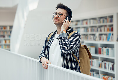 Buy stock photo Headphones, college student man and university library work or research for learning. School campus building, music and live song streaming of a person looking for study books