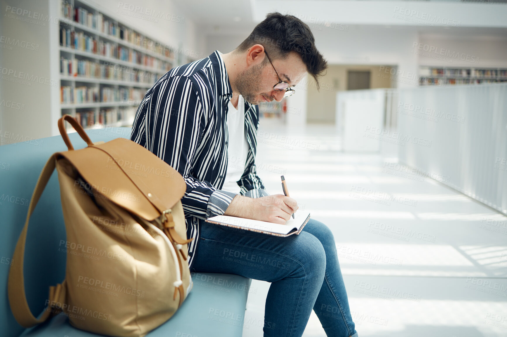 Buy stock photo Library, student and college man writing ideas for educational task in notebook with focus. Learning, knowledge and education of smart university guy thinking of assignment with concentration.

