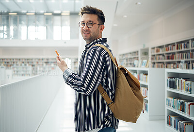 Buy stock photo Student man, library portrait and phone, smile and chat on social media for communication. College student, smartphone and app for university email in education, learning and studying for future goal