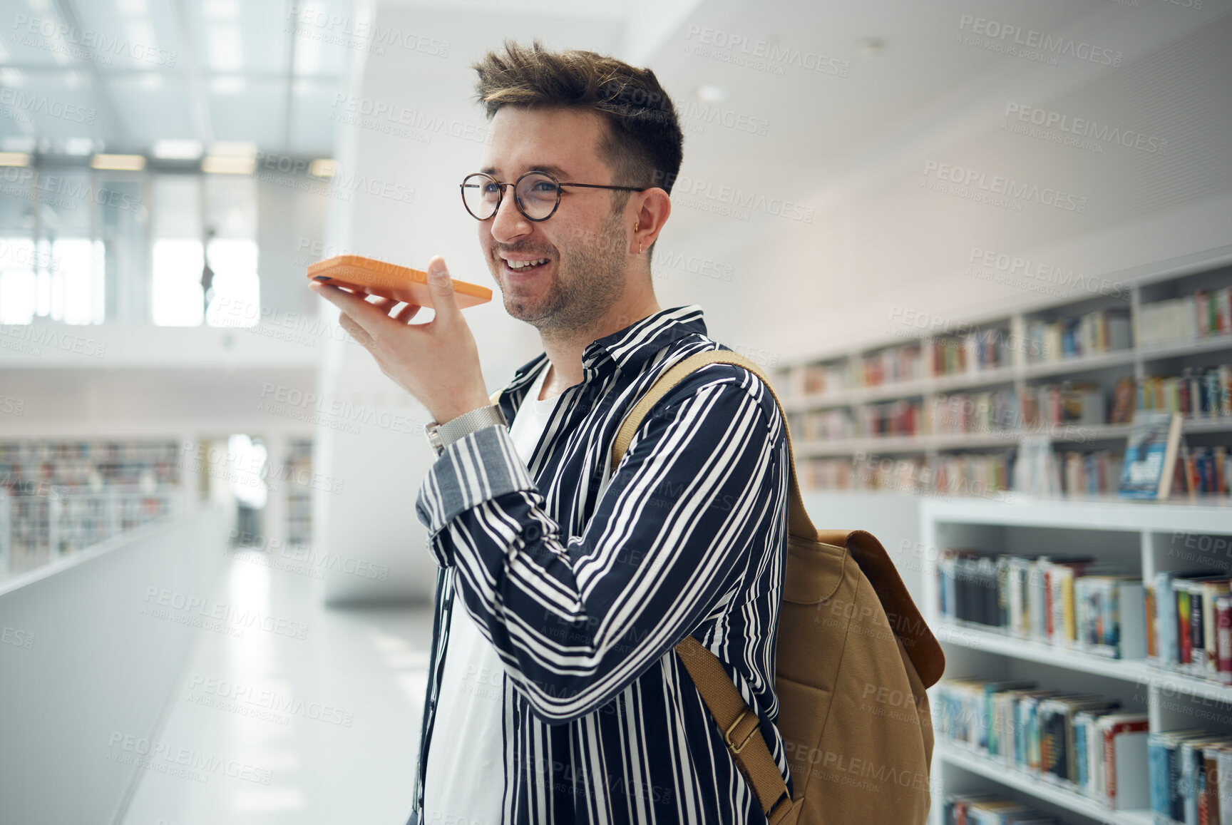 Buy stock photo Man, phone call and speaker in library, smile and connection for communication, talking and planning study date. Young male, student or academic with smartphone, speaking or conversation in bookstore