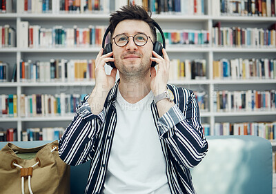 Buy stock photo Library, student and man with music headphones in university, college or school. Education, learning scholarship and face of young male streaming educational podcast, radio or song, audio or album.