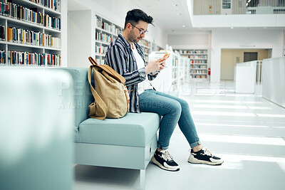 Buy stock photo Library, university and man with phone on sofa for education, research and checking social media. Networking, knowledge and male student on smartphone, mobile app and website in college bookstore