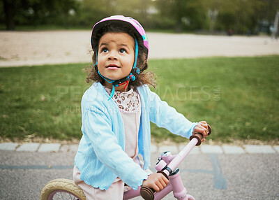 Buy stock photo Cycling, fun and child on a bike in the park, outdoor activity and learning in New Zealand. port, happiness and girl kid playing on a bicycle ride in the neighborhood street or road in childhood