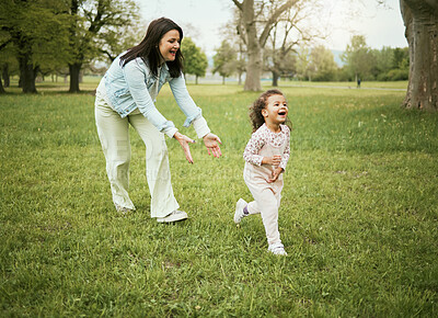 Buy stock photo Mother, girl child and running in park with love, bonding or happiness on grass field for care on holiday. Mama, kid and playful quality time to relax outdoor, woods or backyard garden for nature fun