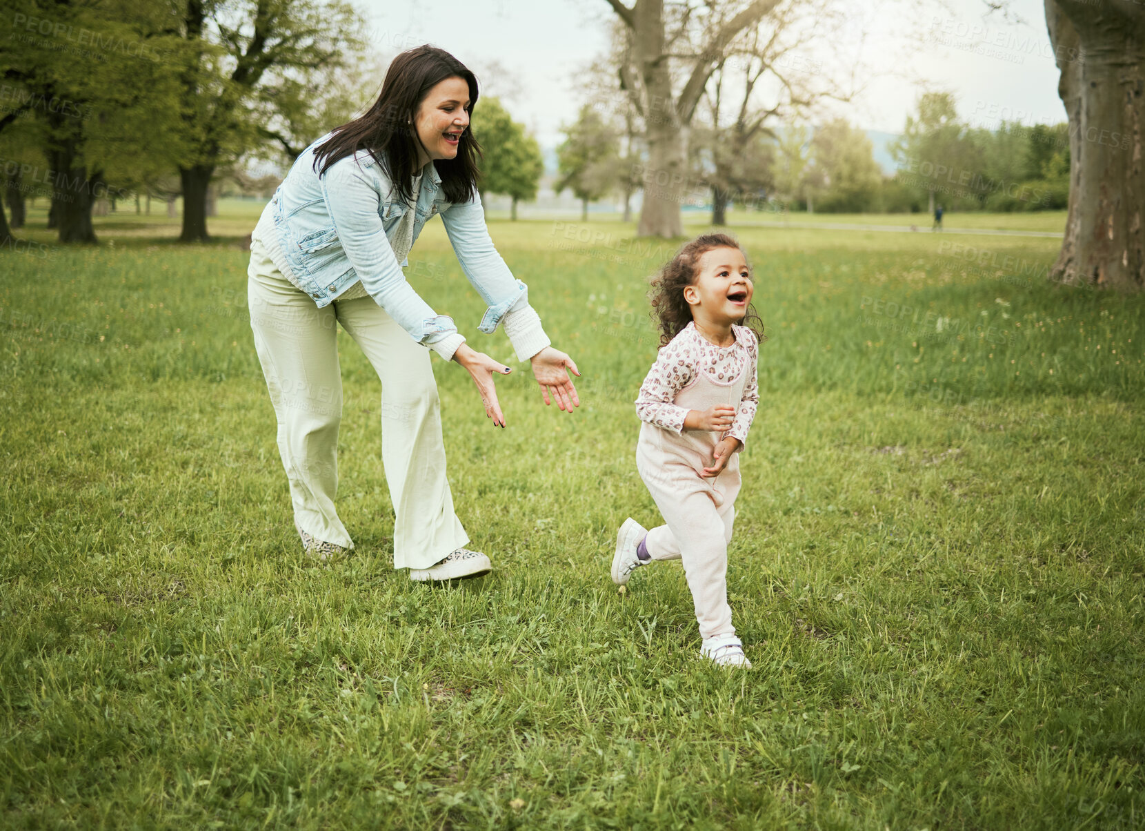 Buy stock photo Mother, girl child and running in park with love, bonding or happiness on grass field for care on holiday. Mama, kid and playful quality time to relax outdoor, woods or backyard garden for nature fun