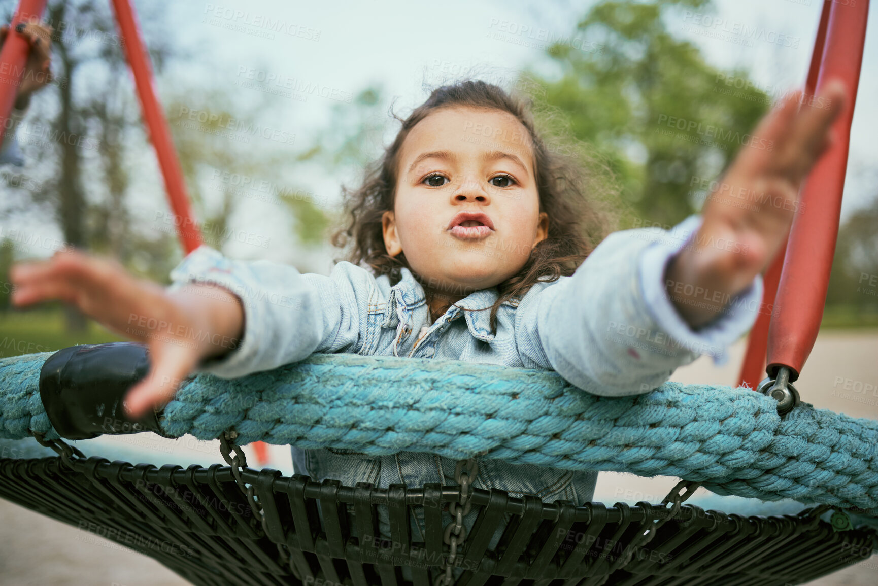 Buy stock photo Young girl play in playground, park and outdoor with portrait, fun and early childhood development with toddler. Kid, freedom and swing, playful and playing during holiday and growth in nature