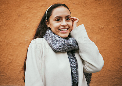 Buy stock photo Happy woman, portrait or hair tuck behind ear by city wall, mockup background or brown mock up in Portugal. Smile, fashion or model in trendy, cool or warm style clothes on building copyspace brand