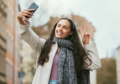 Buy stock photo Travel, peace or happy woman taking selfie for social media in London city on a relaxing holiday vacation or weekend. Smile, hand gesture or excited girl tourist taking fun pictures with pride alone