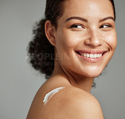 Buy stock photo Face, skincare and woman with back cream in studio isolated on gray background. Beauty cosmetics, thinking and happy young female model with lotion, creme or moisturizer for healthy skin or wellness