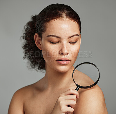 Buy stock photo Skincare, magnifying glass and woman in studio for skin, body and wellness against a grey background. Beauty, inspection and girl model relax after grooming, hygiene and cosmetic care while isolated