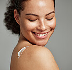 Face, skincare and back of woman with cream in studio isolated on gray background. Cosmetics, beauty dermatology and happy female model with lotion, creme or moisturizer for healthy skin or wellness.