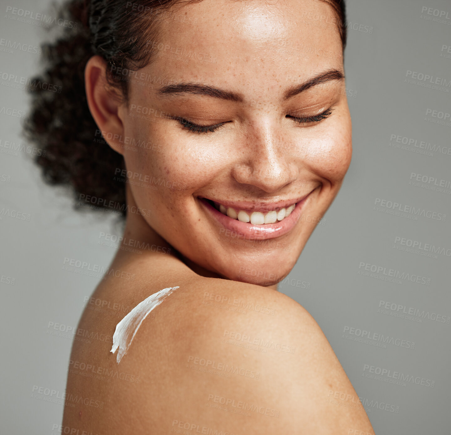 Buy stock photo Face, skincare and back of woman with cream in studio isolated on gray background. Cosmetics, beauty dermatology and happy female model with lotion, creme or moisturizer for healthy skin or wellness.