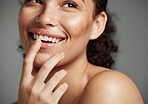 Woman, sugar scrub and lips with smile for skincare, makeup or cosmetics against a grey studio background. Happy female smiling in happiness for facial cosmetic, lip dermatology or mouth exfoliation