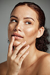 Sugar scrub, face and lips of woman in studio isolated on a gray background. Thinking, cosmetics and skincare of female model with lip dermatology product for exfoliation, cleaning and healthy skin.