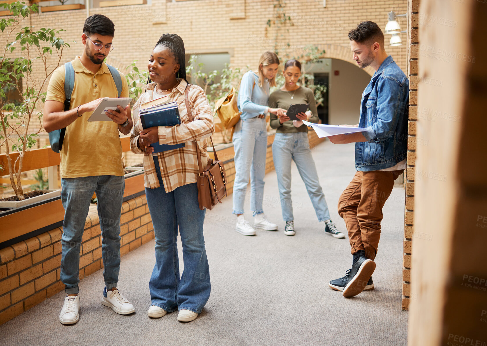 Buy stock photo Students, college and education, tablet and books for learning, scholarship and collaboration in campus hallway. University with people studying together, learn with diversity and academic goals