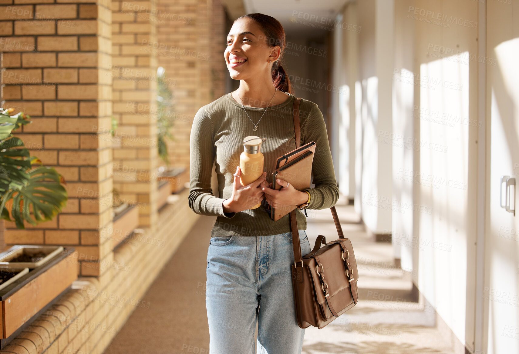 Buy stock photo Young girl, walking and happy in college building for learning, education and future success vision. University woman, student smile and walk in lobby for studying motivation or knowledge mindset 