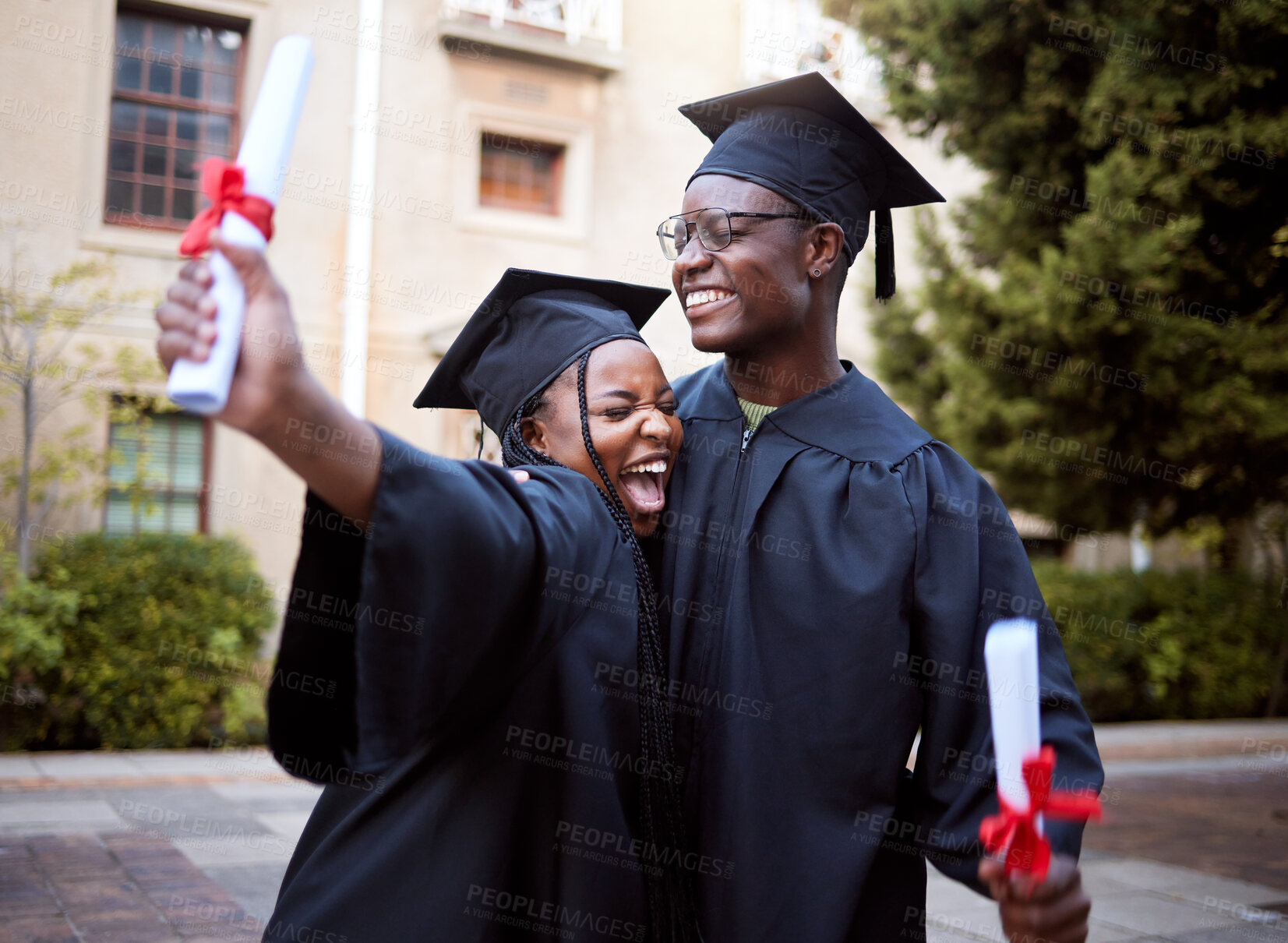 Buy stock photo Black students, hug and celebration for graduation, education and achievement on university, campus and success. African American woman, man or academics with smile, embrace or joy for college degree