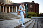 Woman, student on campus stairs and college, education with learning and academic goals with scholarship outdoor. Walking, study and happy person with success, college life and studying for growth