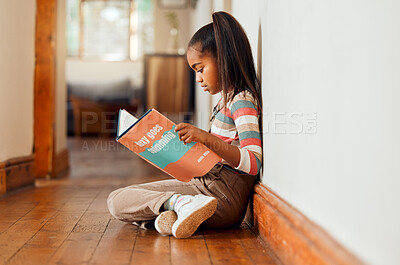 Buy stock photo Little girl, book and reading on wooden floor for story time, learning or education relaxing at home with smile. Happy child smiling, sitting and enjoying books, read or stories at the house indoors