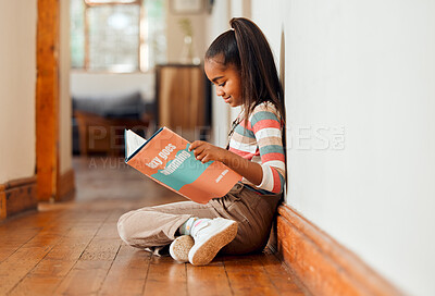 Buy stock photo Little girl, book and reading on wooden floor for learning, education or story time relaxing at home with smile. Happy child smiling, sitting and enjoying books, read or stories at the house indoors