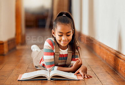 Buy stock photo Knowledge, black girl and reading on the floor, smile or hobby for learning, creative or relax on weekend. Young lady, African American female on ground or book for story time, literature or chilling