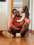 Family, father and daughter hug in their home, happy and relax while bonding and having fun. Love, black family and girl with parent, smile and embrace, content and sitting on a floor together