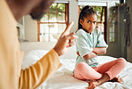 Scolding, angry and kid on bed in home with unhappy,  annoyed and tantrum expression. Serious conflict, problem and upset father in black family disappointed with young child in house.
