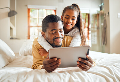 Buy stock photo Black family, tablet or education with a father and daughter lying together on a bed in their home for learning. Relax, internet and kids with a man and girl in a bedroom for growth or development