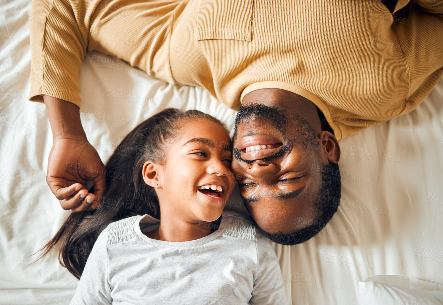 Buy stock photo Black family, father and daughter love on a bed with a smile on face or laughing at funny memory. Above man and child together in home bedroom for bonding, support and care with safety and security 