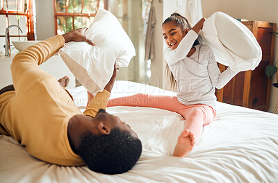 Buy stock photo Happy pillow fight, father and child on bed playing, bonding and crazy fun for dad and daughter time in home. Family, love and playful energy, black man with girl hitting and laughing in bedroom.