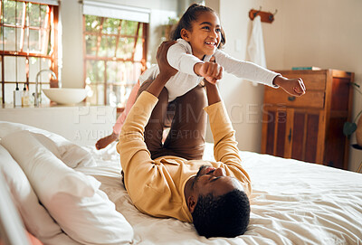 Buy stock photo Happy, fun and dad with child on bed playing, bonding and airplane game for father and daughter time in home. Family, love and playful energy, black man holding girl in air and laughing in bedroom.