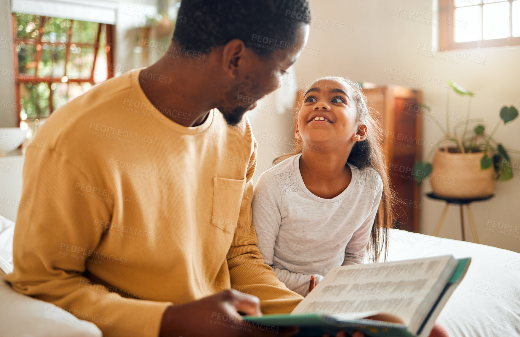 Buy stock photo Happy, child and father reading a book for education, learning and information in their family home. Love, smile and African dad with a girl in the bedroom for a story, bonding and quality time