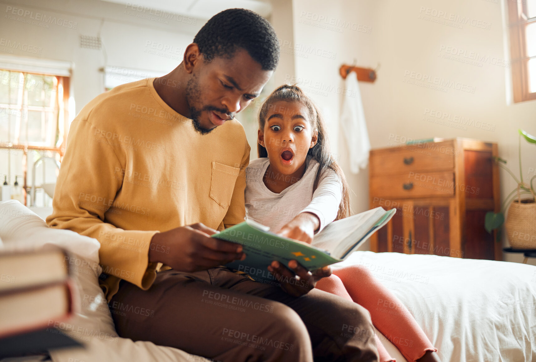 Buy stock photo Father, child and book in shock on bed for story time, reading or learning literature sitting at home. Dad and daughter surprised or shocked in frightened expression holding textbook in bedroom